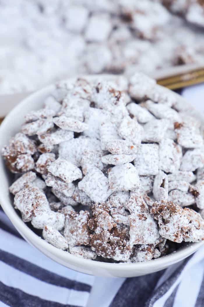 Muddy Buddies in a bowl and on a baking sheet