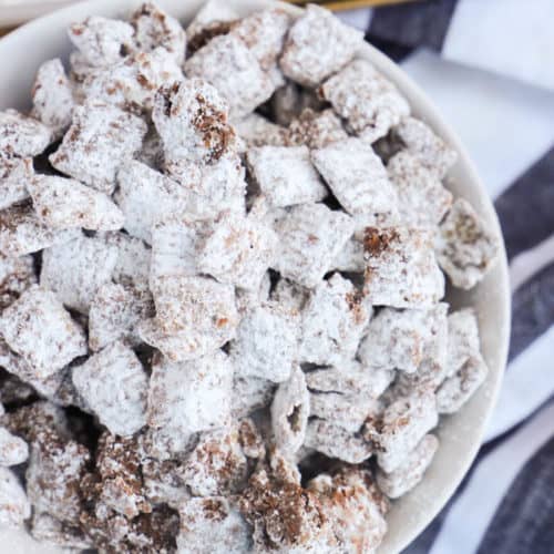 Muddy Buddies in a white bowl and black napkin