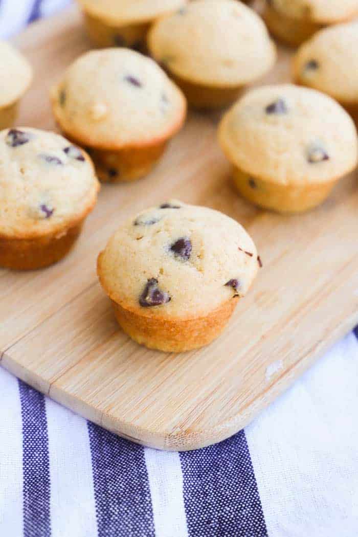Mini Chocolate Chip Muffins on a wooden board.