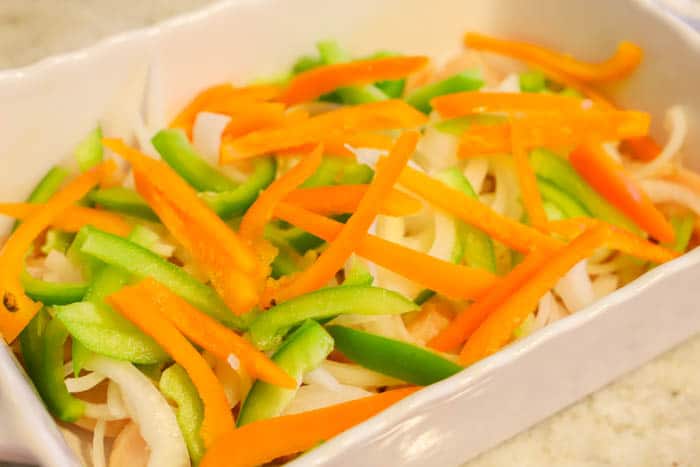 adding ingredients to the casserole dish