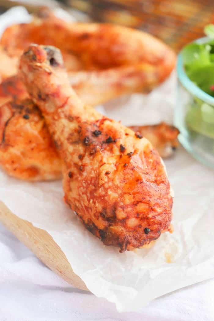 Baked Honey Garlic Chicken Legs on a cutting board