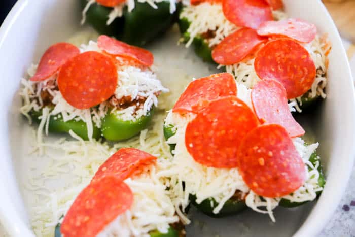 Pizza Stuffed Peppers before cooking topped with cheese