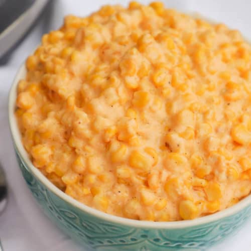 Slow Cooker Cheesy Creamed Corn in a blue bowl