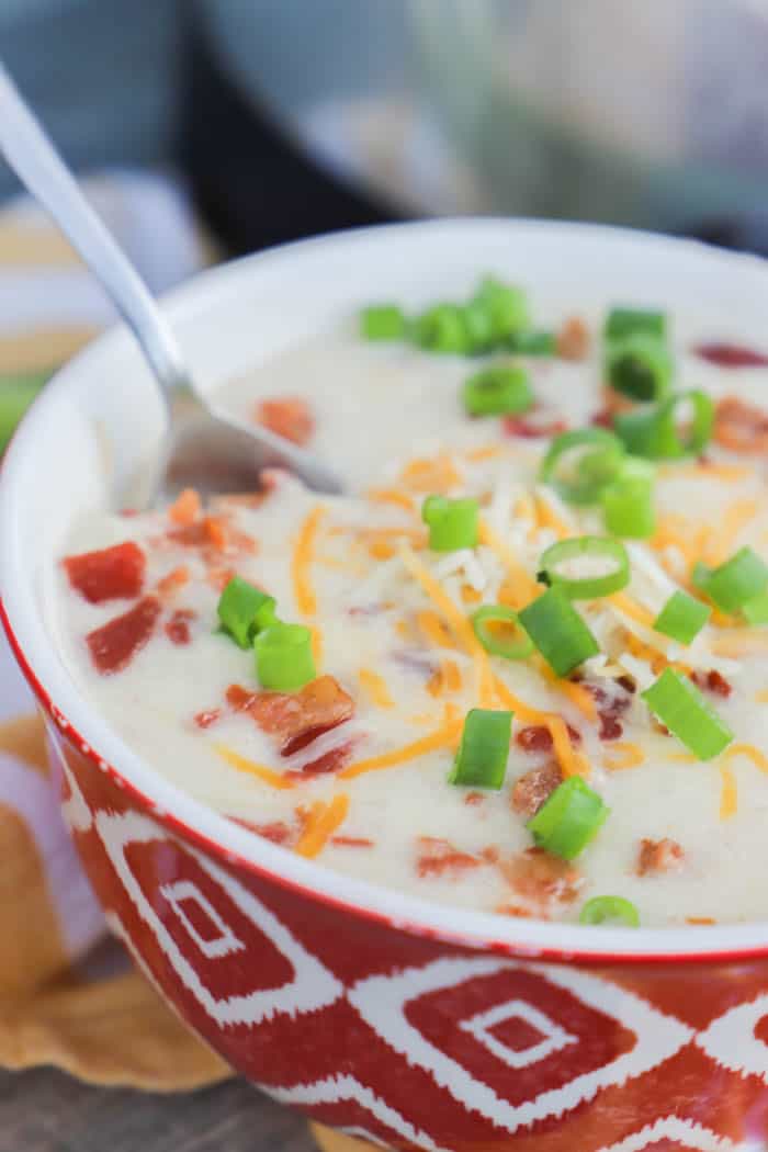 Slow Cooker Loaded Baked Potato Soup with a spoon