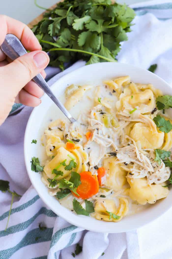 Slow Cooker Creamy Chicken Tortellini Soup on a spoon