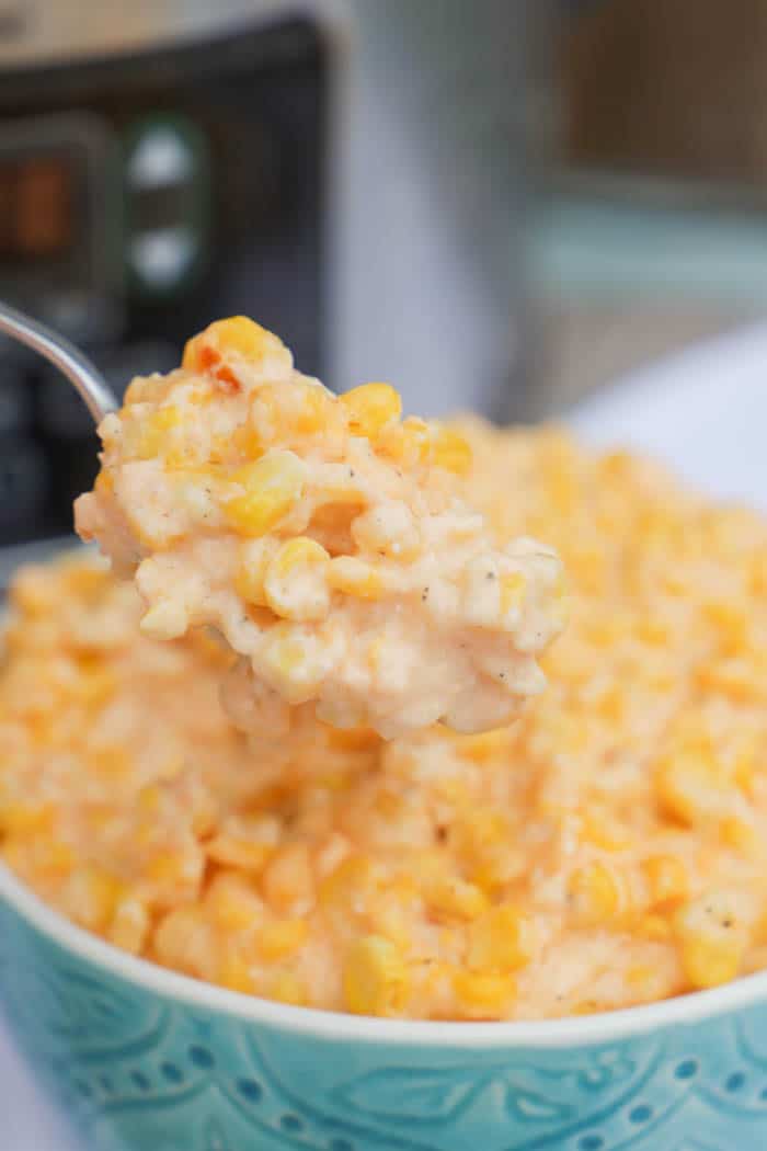 Slow Cooker Cheesy Creamed Corn on a spoon close up shot