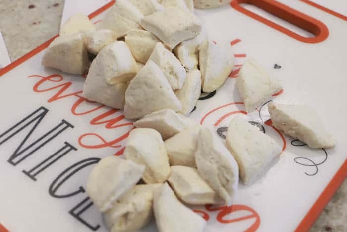 dicing biscuits on a cutting board