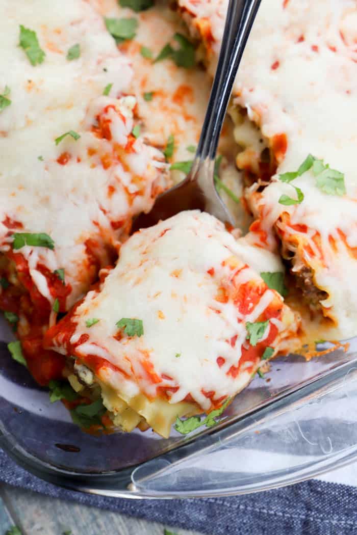 Lasagna Roll Ups being served on a silver spoon