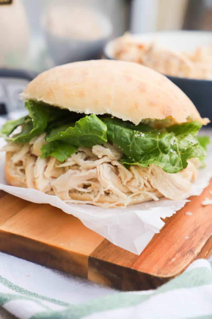 Slow Cooker Chicken Caesar Sandwich on a bun with lettuce