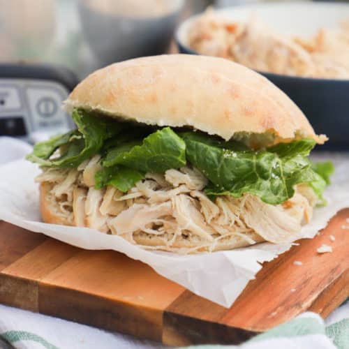 Slow Cooker Chicken Caesar Sandwich on a cutting board