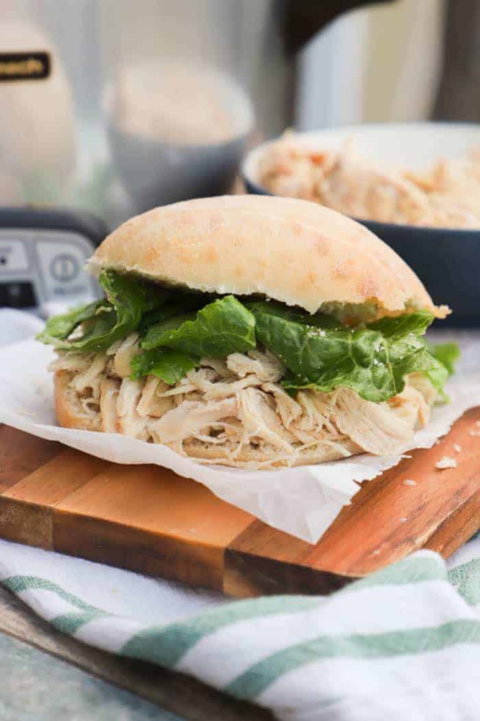 Slow Cooker Chicken Caesar Sandwich on a cutting board