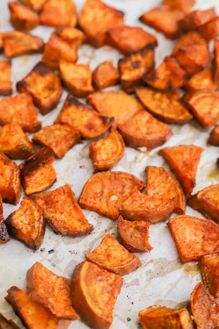 Cinnamon Sugar Roasted Sweet Potatoes on parchment paper