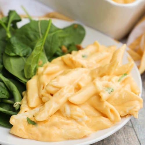 Cheesy Penne Bake in a plate with salad