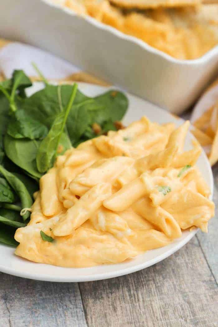 Cheesy Penne Bake in a plate with salad