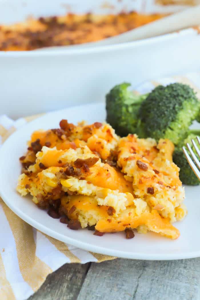 Bacon and Corn Casserole on a plate with broccoli