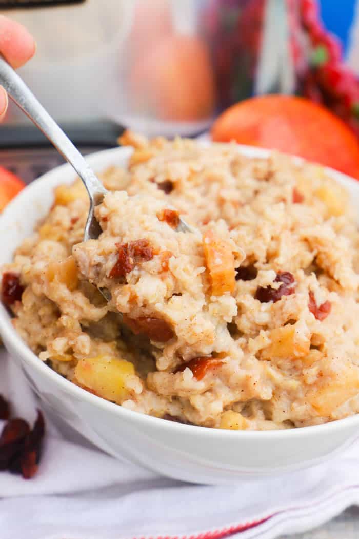 Slow Cooker Cranberry Apple Oatmeal with a metal spoon