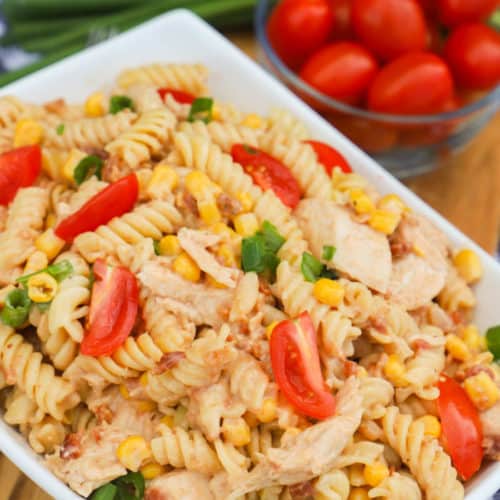 BBQ Chicken Pasta Salad in a white bowl with side of tomatoes