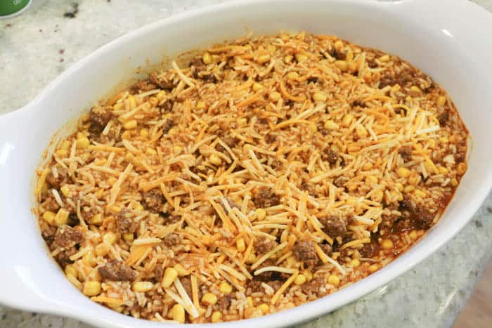 adding uncooked ingredients to the casserole dish