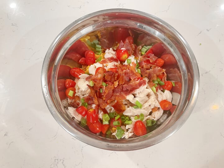 adding ingredients to silver mixing bowl