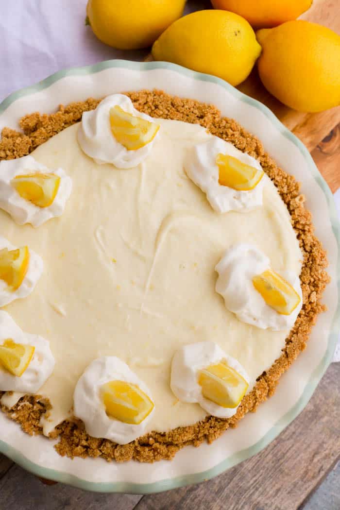 top view picture of No Bake Lemon Pie in a white pie pan topped with lemon slices