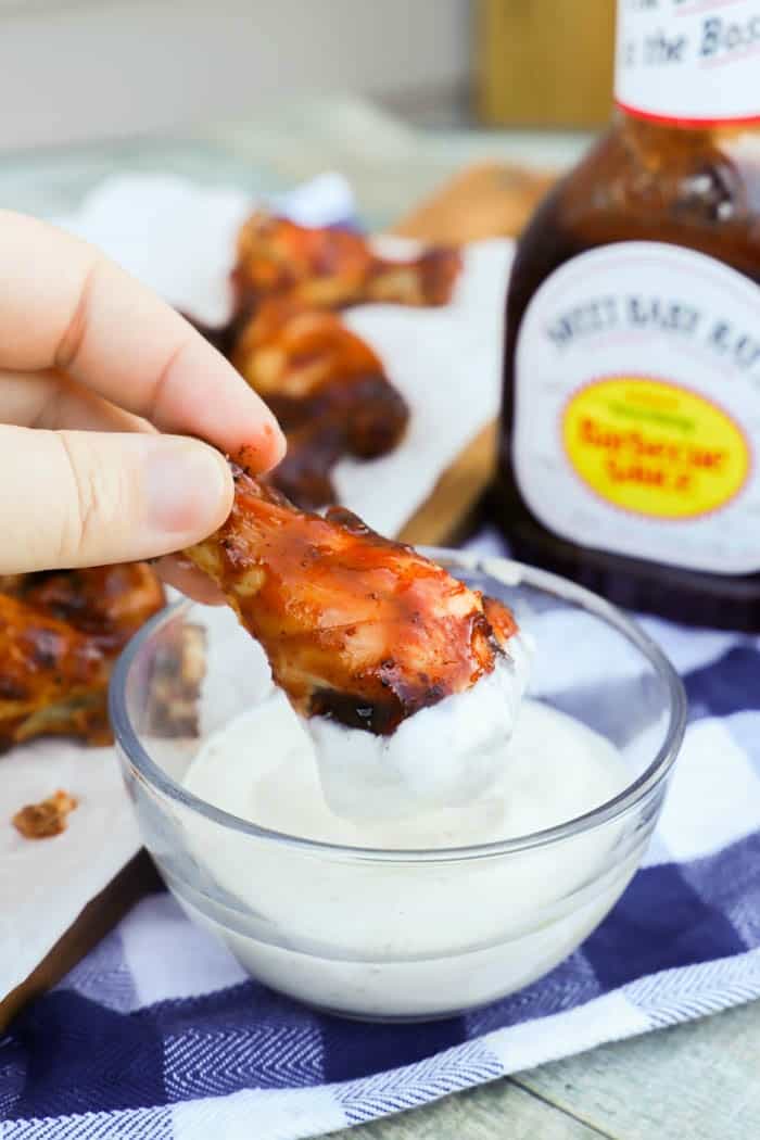 BBQ Chicken Wings being dipped in ranch dressing