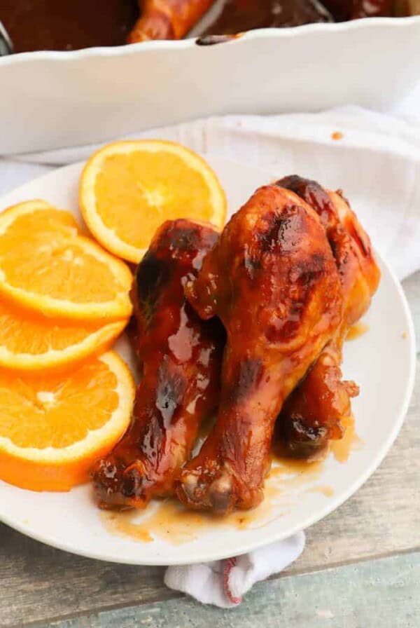 Easy Orange Chicken Drumsticks on a white plate