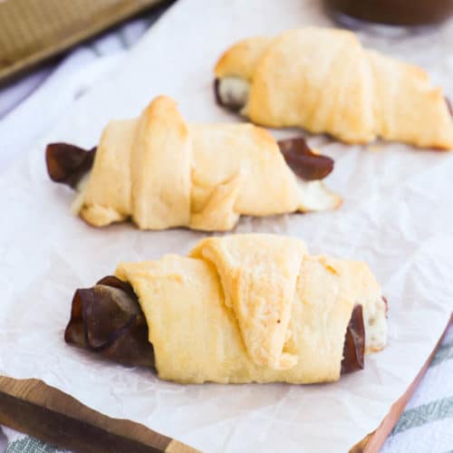 French Dip Crescents on a wooden cutting board