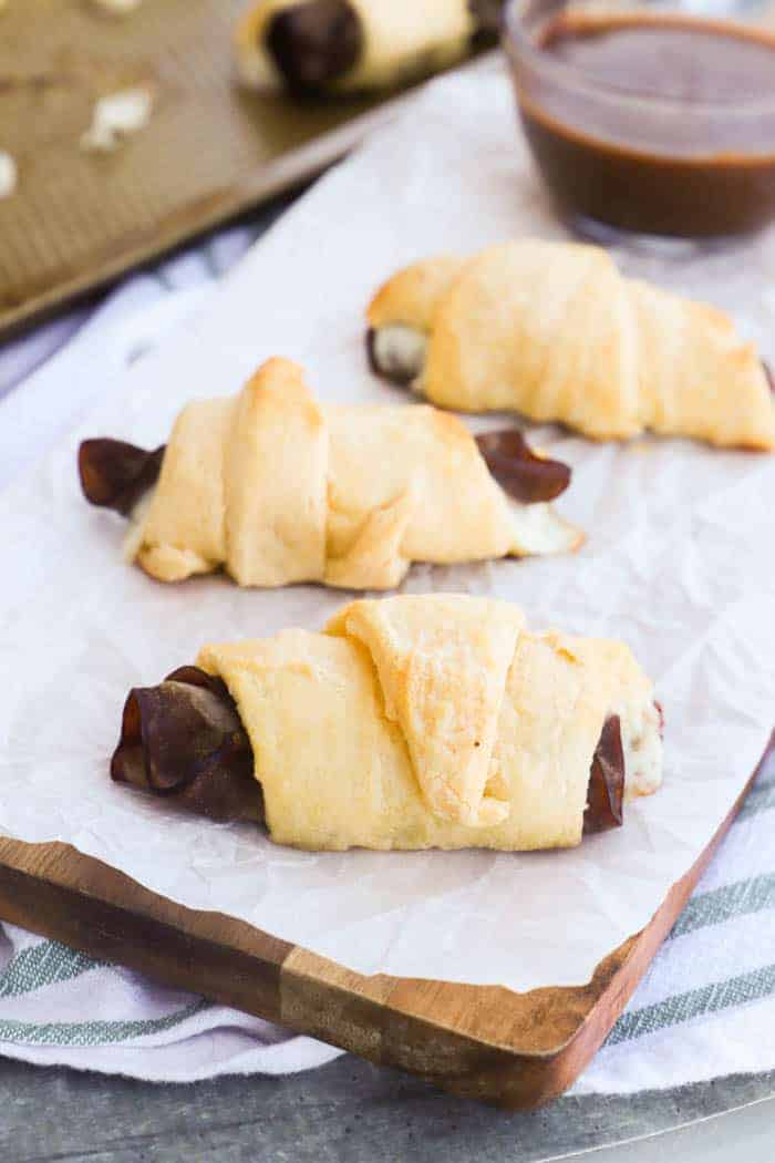 French Dip Crescents on a wooden cutting board