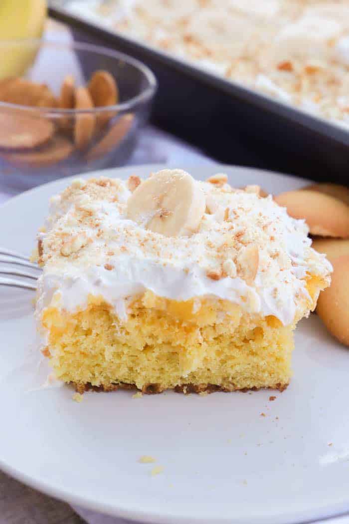 slice of Banana Pudding Poke Cake on a white plate