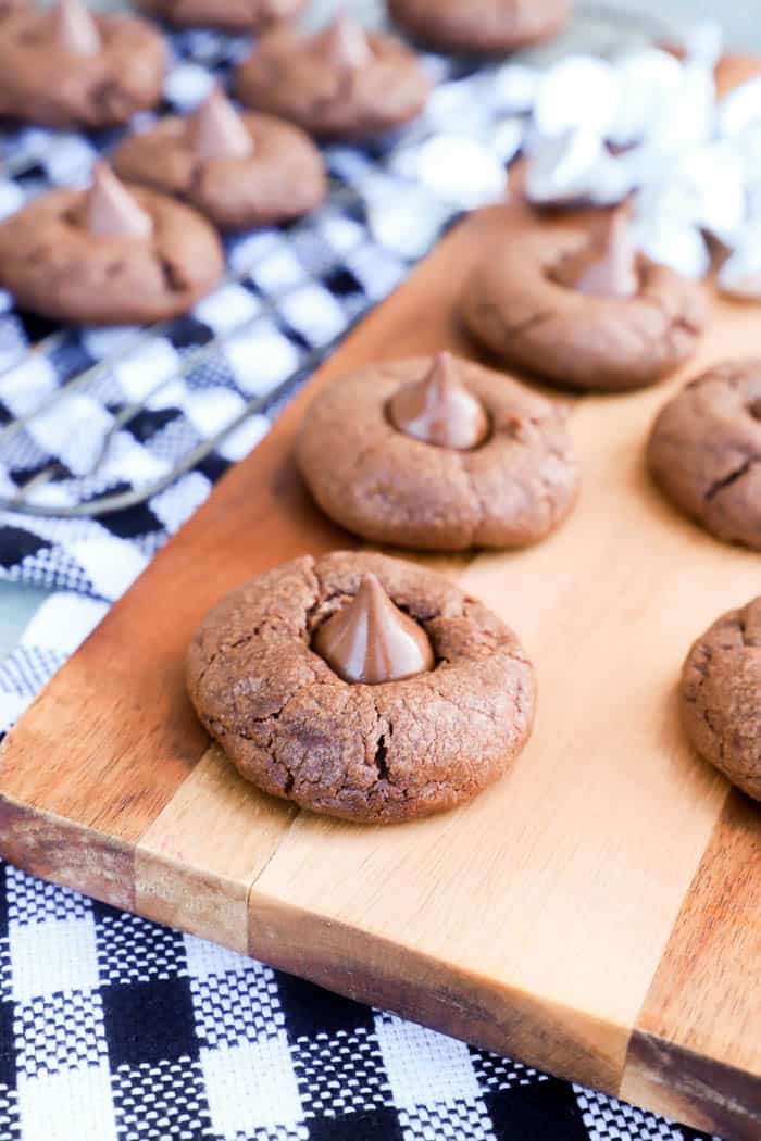 several Chocolate Blossom Cookies on a wooden serving board