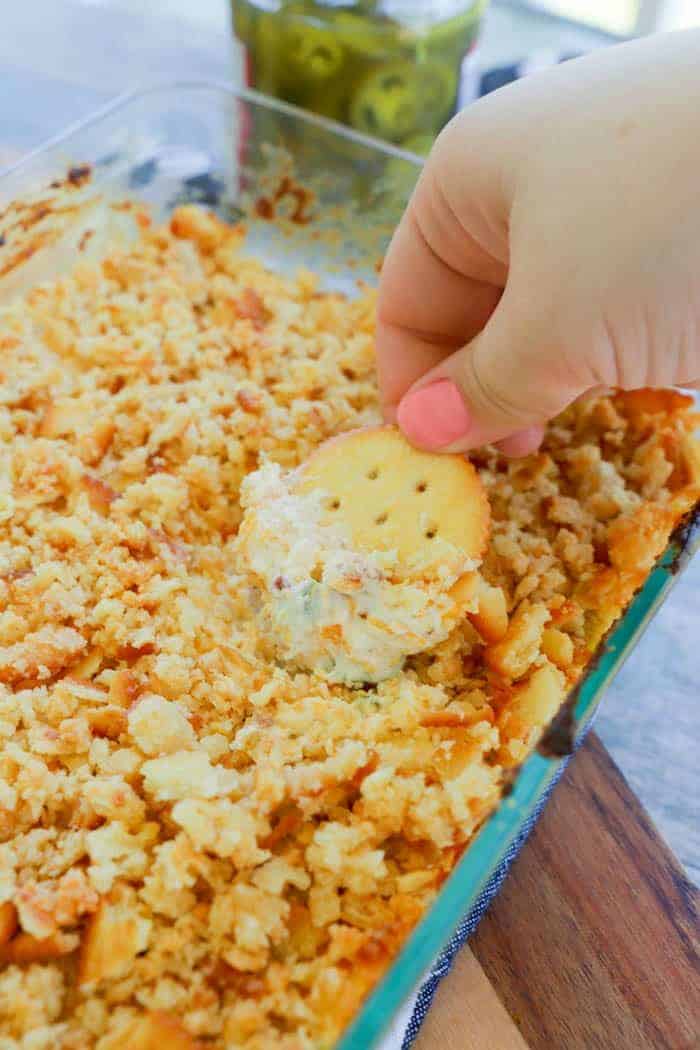 Jalapeno Popper Dip with ritz cracker topping in clear dish