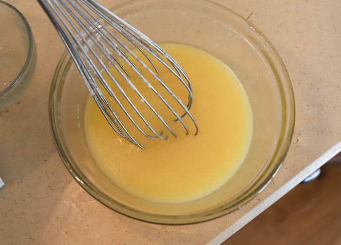 preparing orange juice glaze for cake