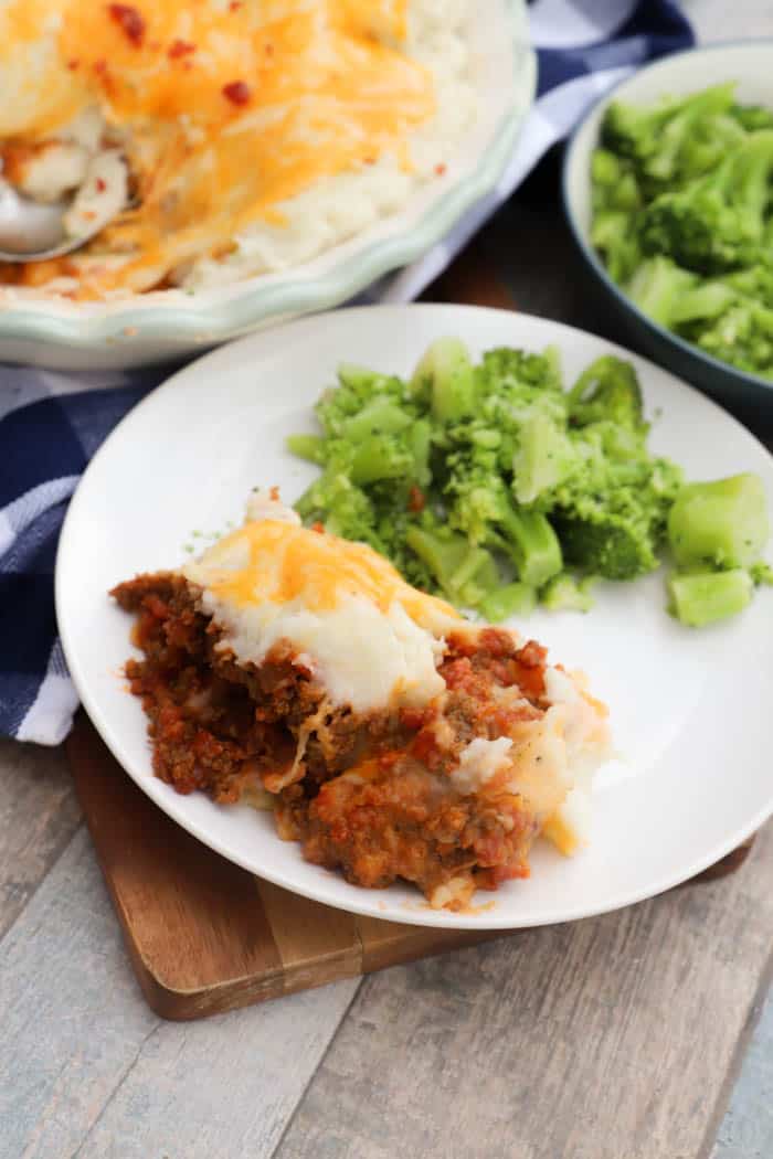 Bacon Cheeseburger Shepherd's Pie on a white plate with broccoli