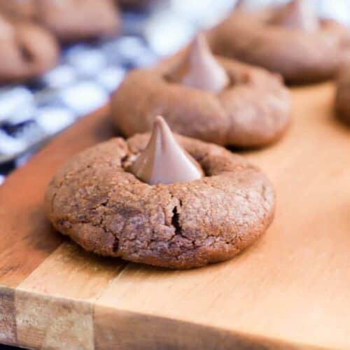 Chocolate Blossom Cookies sitting on a serving dish with black napkin