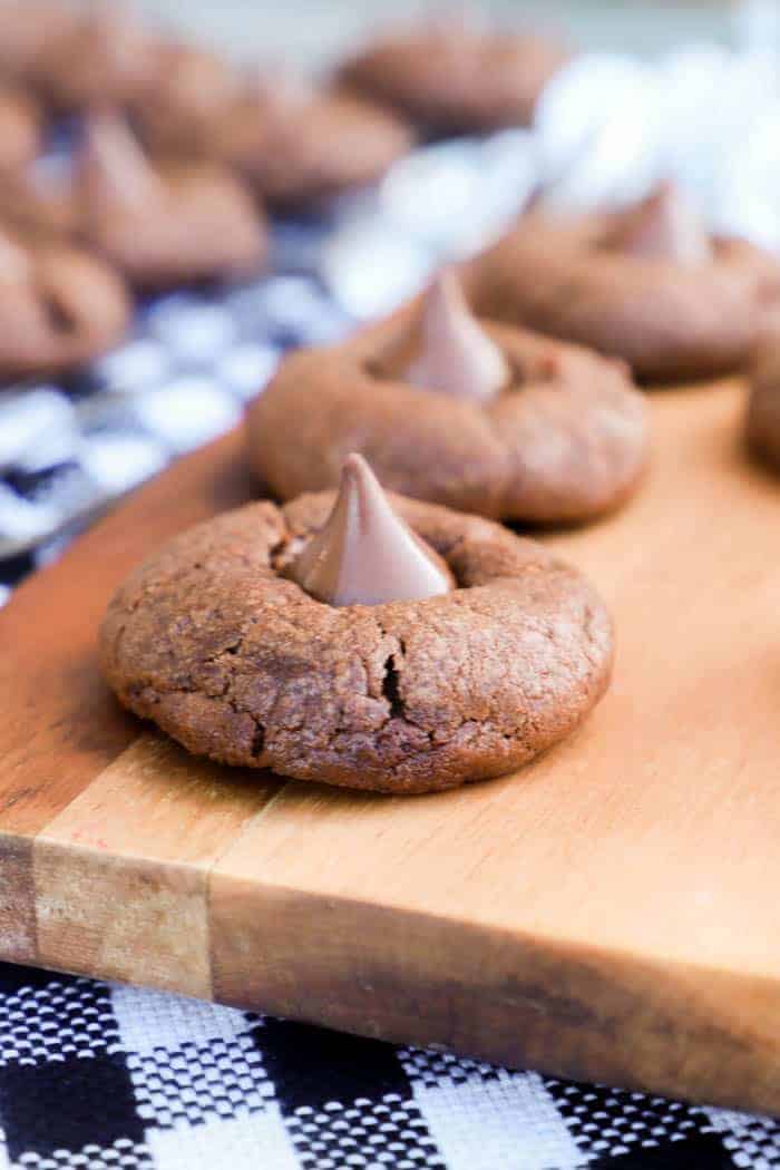 Chocolate Blossom Cookies sitting on a serving dish with black napkin