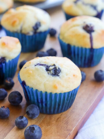 Greek Yogurt Blueberry Muffins on a brown cutting board