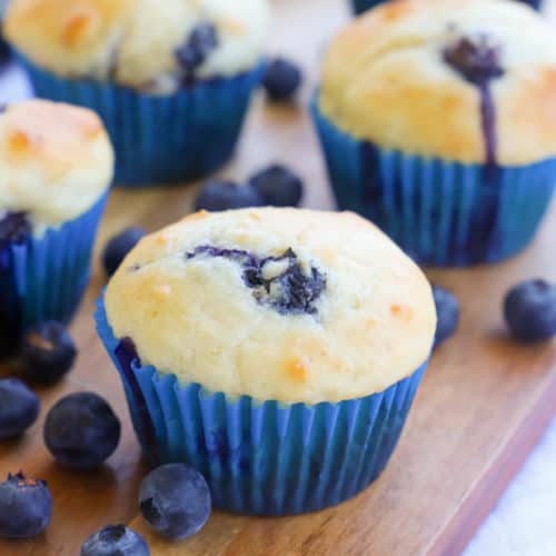 Greek Yogurt Blueberry Muffins on a brown cutting board