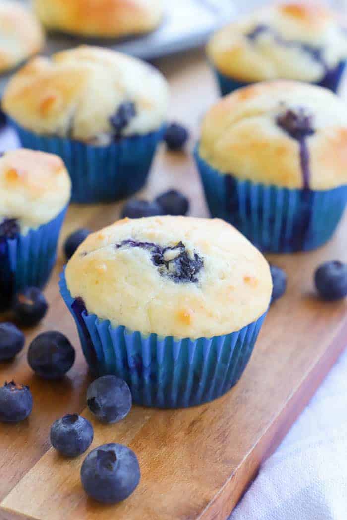 Greek Yogurt Blueberry Muffins on a brown cutting board