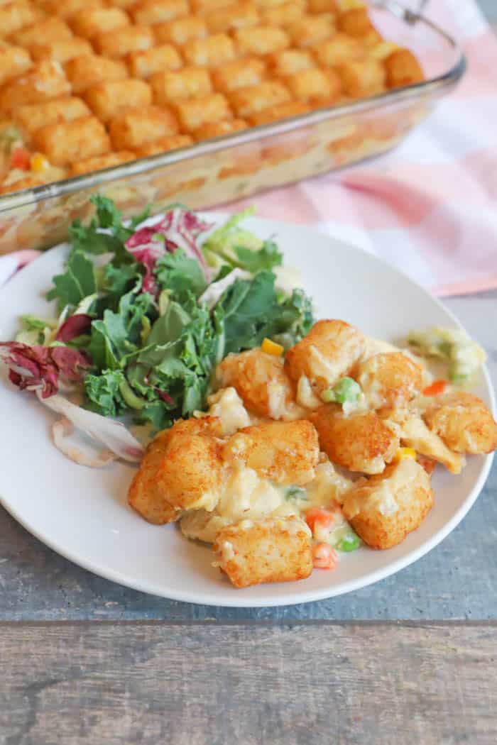 Tater Tot Chicken Pot Pie on a white plate with salad