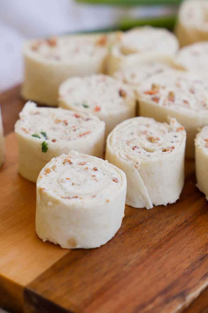 Bacon Ranch Pinwheels sliced and served on a wooden tray