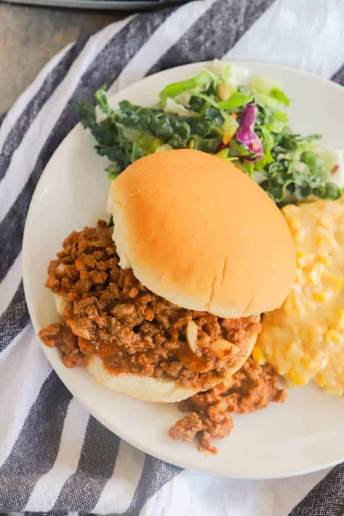 Slow Cooker Sloppy Joes on a plate with salad