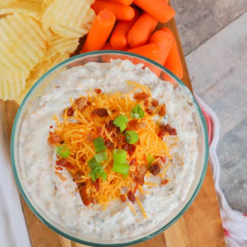 Loaded Ranch Dip in a bowl topped with cheese and bacon