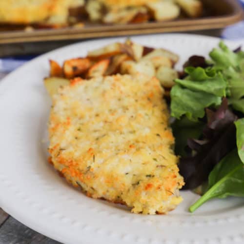 Sheet Pan Pork Chops and Potatoes on a white plate with salad