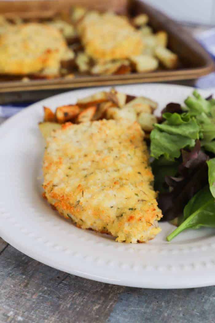 Sheet Pan Pork Chops and Potatoes on a white plate with salad