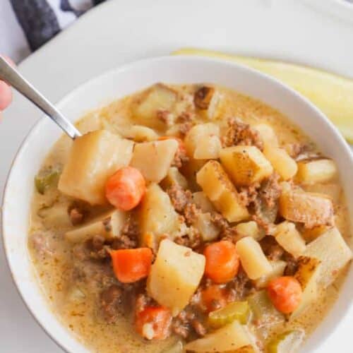 Slow Cooker Cheeseburger Soup with silver spoon inside bowl