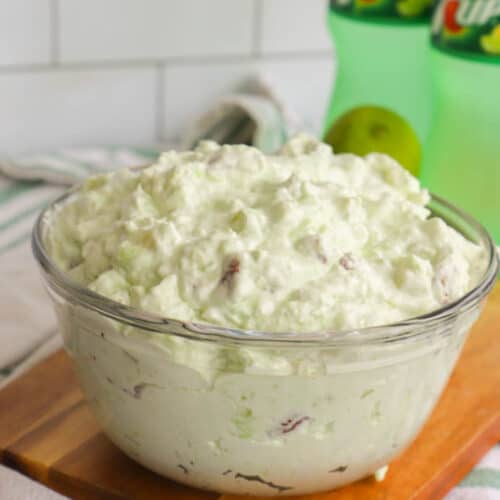 7-Up Salad in a clear bowl on wooden board