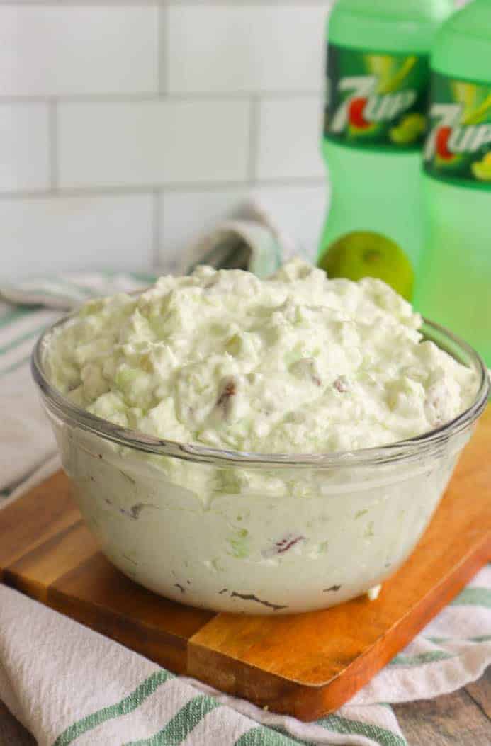 7-Up Salad in a clear bowl on wooden board