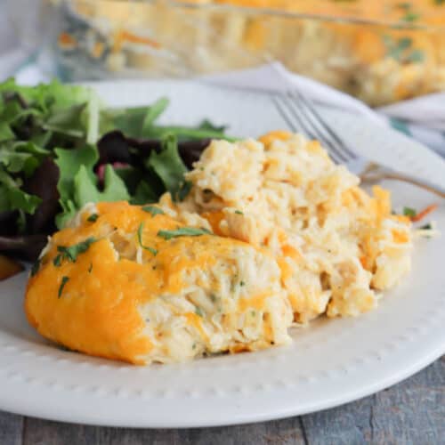 Cheesy Ranch Chicken and Rice Casserole on a white plate with salad