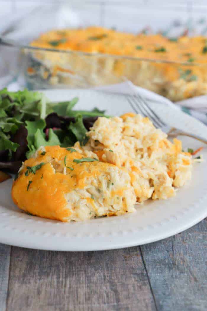 Cheesy Ranch Chicken and Rice Casserole on a white plate with salad