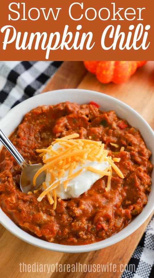  Slow Cooker Pumpkin Chili in white bowl topped with sour cream and cheese